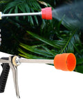 Beefy Zinc Alloy Sprayer Wand With Long Rod High Pressure Water Spray in use for garden irrigation against green foliage