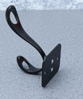 Vintage Matte Black Wall Hooks Set Of Five For Hanging Heavy Coats Umbrellas And Handbags Boasts Dope Industrial Vibes And Rock Solid Screw Mount Hardware, individual matte black hook on a gray surface.