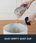 Person emptying the dust cup of Blaze 3 In 1 Stick Vacuum Cleaner With Powerful Suction Lightweight Four Pound Handheld For Quick Cleanups