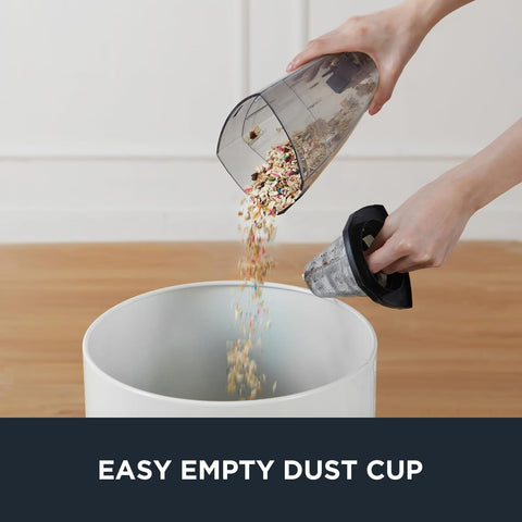 Person emptying the dust cup of Blaze 3 In 1 Stick Vacuum Cleaner With Powerful Suction Lightweight Four Pound Handheld For Quick Cleanups