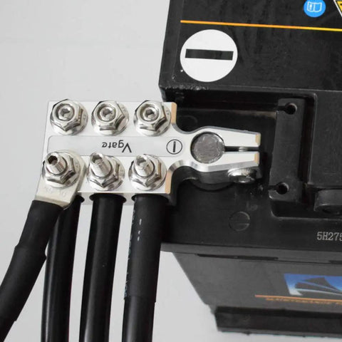 Pro Level Heavy Duty Rock Solid Battery Terminal Clamps Pair 12 Way Power Distribution Block attached to a battery.