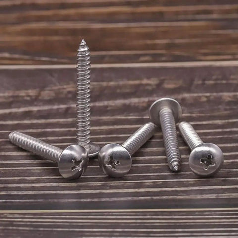 Rock Solid Number 10 Truss Head Screws With Phillips Drive Self Tapping Sheet Metal And Wood Fasteners Crafted From Durable 304 Stainless Steel One Point Five Inch Bright Finish Hardware 100 Piece Pack on a wooden surface.