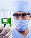 Scientist holding a 100 ml borosilicate glass lab beaker with spout, part of 24 Pack 100 Ml Borosilicate Glass Lab Beakers With Spouts.