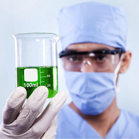 Scientist holding a 100 ml borosilicate glass lab beaker with spout, part of 24 Pack 100 Ml Borosilicate Glass Lab Beakers With Spouts.