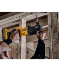 Boss Level 20V Max Brushless Compact Stud And Joist Drill With No Sweat Quick Change Chuck and Smart Anti Rotation Safety Brake in use on a framing site.