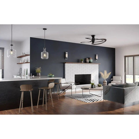 Latrobe Collection 1-Light Clear Glass Coastal Pendant Light In Matte Black With Bottle-Shaped Shade above kitchen island
