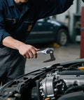 Mechanic using Ninety Degree Bend Pry Bar Wrench Adapter For Three Eighths Inch Drive Crowbar With Hammerable Head on engine