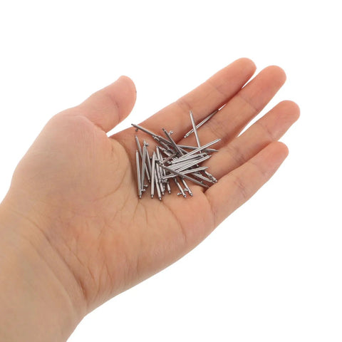 Hand holding stainless steel pins from Pro Grade 110 Piece Stainless Steel Watch Spring Bar Pins Replacement Kit With Quick Release Springs For Secure Strap And Band Link Repair, Heavy Duty Tool Set