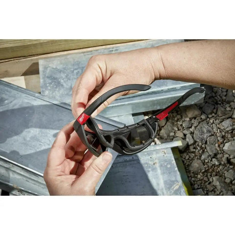 Hands holding Rectangular Polarized High Performance Safety Glasses With Gasket Black Eye Protection for Work and DIY Projects