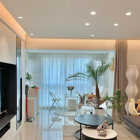 Smooth 10W Dimmable Cob Led Spotlight 12 Pack illuminating a modern living room with plants and stylish decor.