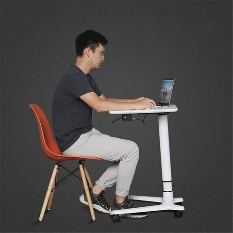 Rock Solid Rolling Laptop Cart With Height Adjustable Standing Desk and Smooth Glide Wheels For Bed Sofa Gaming Or Home Office Flex Setup, side view of user typing on laptop