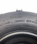 Close-up of Beefy 16x8-7 ATV Tire With Rim showing nylon material and 'Not for Highway Service' text
