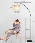 Lit Tall Arc Floor Lamp With Remote Control 81 Inch Tall Dimmable LED Stepless Color Temperature Remote Dimmer Adjustable Hanging Drum Beige Shade Modern Floor Lamp For Living Room And Bedroom with person seated nearby