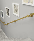 Heavy Duty Gold Wall Mount Staircase Handrail Kit No Sweat Setup Wrought Iron Banister Bracket Set Quick Install Indoor Outdoor Safety Step Railing 17 Foot Long mounted on wall with artwork.