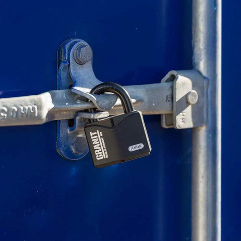 Granit Alloy Steel Padlock With Beefy Hardened Shackle Keyed Different High Security Lock securing a blue metal gate.