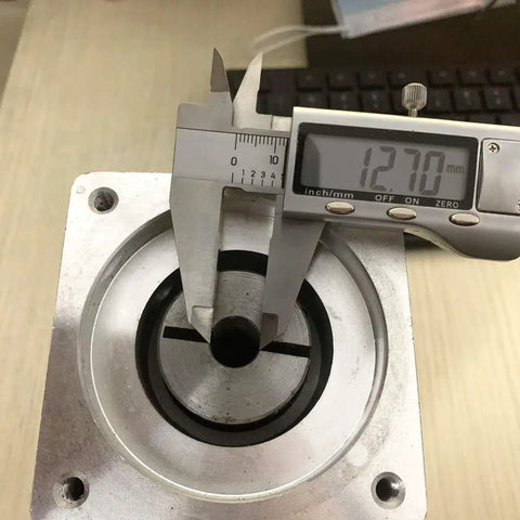Close-up of Beefy 10 To 1 Planetary Gearbox Reducer Nema 34 with 12.7mm input shaft and 86mm flange being measured with a caliper.