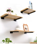 Tough As Nails Dual Pack Wall Mounted Floating Shelf Brackets In Industrial Black supporting wooden shelves with decor.