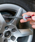 Person using Brake Disc Thickness Measurement Verniers Caliper on car tire, measuring brake thickness accurately.