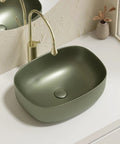 Retro Green Ceramic Above Counter Bathroom Vessel Sink, Artistic Curved Design, Scratch-Resistant & Easy-to-Clean Vanity Sink for Home, Balcony, Guest Bath (23.6in/60cm) viewed from top with faucet.