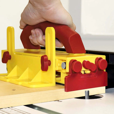Milescraft 3406 GrabberPRO push block for table saws; yellow body with red handle and knobs.