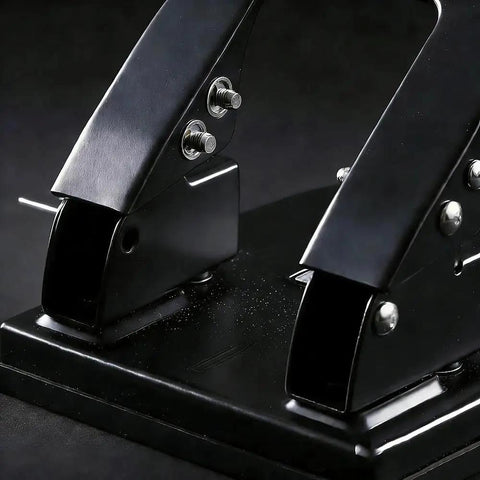 Close-up of a heavy-duty metal two hole punch with 30 sheet capacity, designed for home office and professional use, on a desk.
