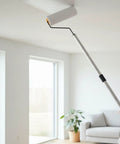 Legit Game Changer Paint Roller Kit With Extendable Stainless Steel Pole painting ceiling in bright room.