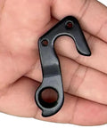 Beefed-Up Derailleur Hanger 266 For GT Bikes Replacement Fits Sensor Zaskar Helion Avalanche Edge Comp 19 Replaces GT ATIDH0233 K33047 CNC Aluminum Alloy Black Bolts Included. Compact black CNC aluminum derailleur hanger in hand, two bolt holes visible.