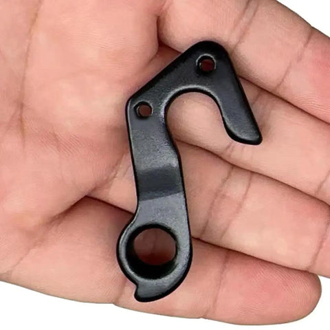 Beefed-Up Derailleur Hanger 266 For GT Bikes Replacement Fits Sensor Zaskar Helion Avalanche Edge Comp 19 Replaces GT ATIDH0233 K33047 CNC Aluminum Alloy Black Bolts Included. Compact black CNC aluminum derailleur hanger in hand, two bolt holes visible.
