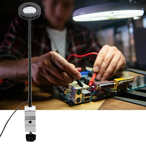 Helping Hands Soldering Station With 3X LED Magnifying Lamp used for precision PCB repair on a stable aluminum base clamped to a table.