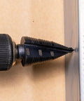 Ultimate Step Drill Bit Set For 7/8 To 1-3/8 Inch Holes With Double Fluted Design in use on metal surface