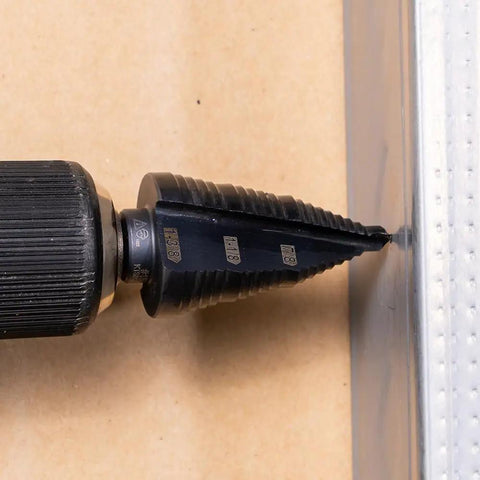 Ultimate Step Drill Bit Set For 7/8 To 1-3/8 Inch Holes With Double Fluted Design in use on metal surface