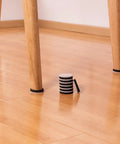 Round 2 Inch Felt Furniture Sliders Pack 24 Piece Heavy Duty Reusable Moving Pads For Sofas And Tables Easy Glide On Hardwood Floors Vinyl Ceramic Tile And Linoleum Non Stick Protection For Heavy Furniture on hardwood floor with some pads installed on chair legs and a stack of sliders in the foreground