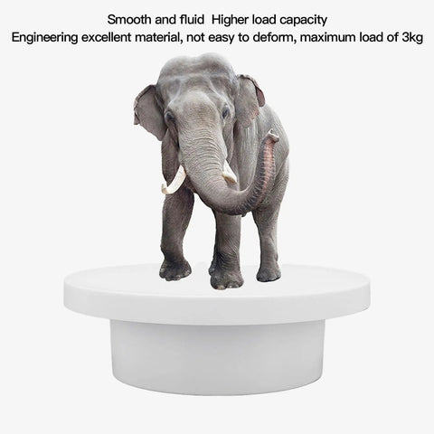 Super Cool Motorized Rotating Display Stand With Smooth 360 Degree Spinning Action showing an elephant on a white turntable.