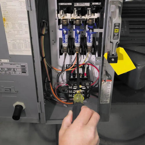 Adjustable 4 To 8 Inch Screwdriver With Removable Shaft Dual Tips Phillips Size 2 And One Quarter Inch Slotted in use on electrical panel