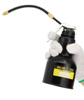 Side view of a black metal DOWELL pistol pump oiler with curved hose, 500 ml, held by white-gloved hand