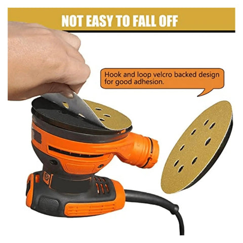 Hand applying a 5 inch hook loop sanding disc to an orbital sander, showing strong adhesion for effective surface prep.