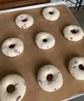 Heavy Duty PTFE Dehydrator Sheets 14 Inch Nonstick Baking Mats And Oven Liners For BBQ Hot Plate Reusable Heat Resistant Food Safe Kitchen Gear That Makes Prep A Cinch with raw bagels on top.