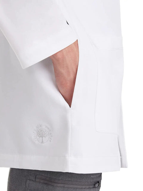 Relaxed Fit Men's Lab Coat With 5 Pockets, Side Slits, Knit Details And 360 Degree Stretch For Easy Movement, White, 34.5 Inch Back Length, X Large, Ideal For Doctors, Nurses, Lab Techs And Medical Students, close-up of side slit and pocket.