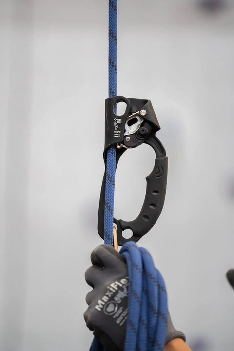 Passport Handled Rope Ascender with ergonomic rubber grip on blue rope, compact design, black left hand model