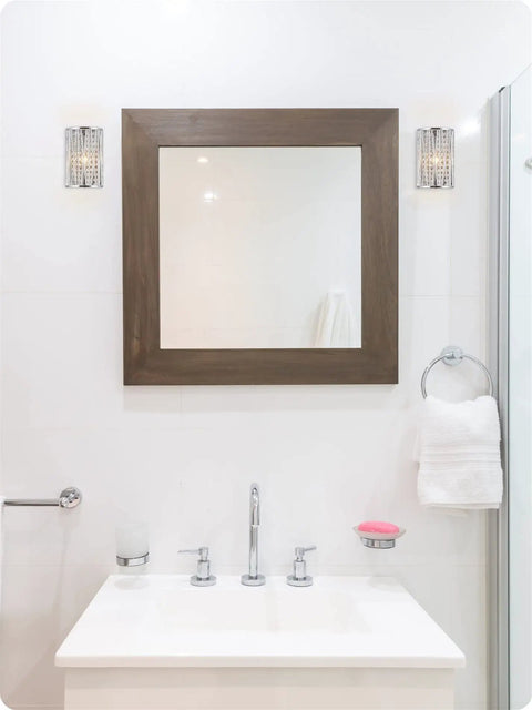 Modern bathroom with wall-mounted lights, mirror, and sink; no Gemma 15 Inch Modern Chic Four Light Crystal Flush Mount Chandelier visible.