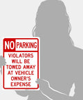 No Parking Violator Will Be Towed Sign Built Tough From Premium Aluminum For Indoor Outdoor Use With Rust Free Construction And High Visibility To Stop Unwanted Parking In Any Lot Garage Or Driveway, shown held by person