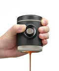 Hand holding Portable Espresso Maker With 18 Bar Pressure Picopresso For Travel Lovers Delivers Quick Barista Grade Espresso On The Go Anywhere