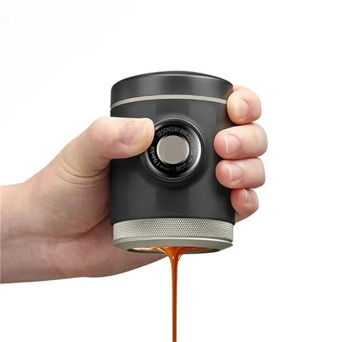 Hand holding Picopresso Portable Espresso Maker With 18 Bar Pressure For Quick Pulls On The Go Ultra Compact Coffee Machine