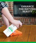 Applying All In One No Fuss Wood Cleaner Conditioner Wax And Polish Spray For Furniture And Cabinets 18 Oz on a wooden table