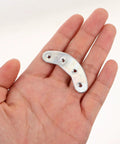 Hand holding one piece of Three Pairs Metal Heel Plates For Shoes And Boots Iron Sole Protectors Anti Wear Pads Heel Taps Tips