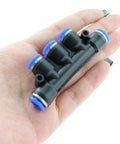 Hand holding Five Way Inline Manifold Fittings Push In Quick Connect For 6mm Tube Outer Diameter 1/4 Inch Air Line High Pressure 0 To 150 PSI