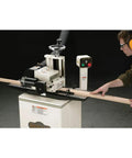 Badass Two Hp Planer Molder With Stand And Power Feed 220 Volt Woodworking Beast in use with wood plank.