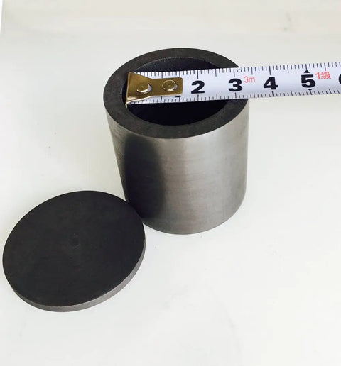 Top Shelf Graphite Crucible With Secure Lid For Heavy Duty Lab Smelting And Quick Melting Projects Four Inch Square showing measurement tape.