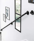 Sleek Black Wrought Iron Stair Rails With Super Grippy Non Slip Coating Zero Hassle Diy Wall Mount Setup Heavy Duty Indoor Outdoor Banister For Seniors Kids Hallway Loft And Bathroom 19 Feet Long mounted on a white wall.