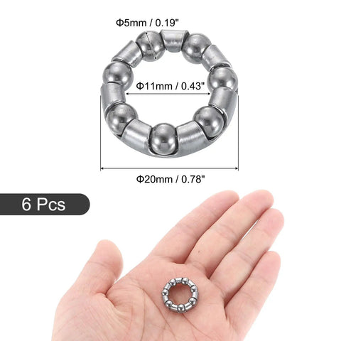 Close-up of Bicycle Crank Ball Bearings Kit 3/16 Inch 5mm 7 Balls 10 Pack Replacement Bearings on a hand for scale.